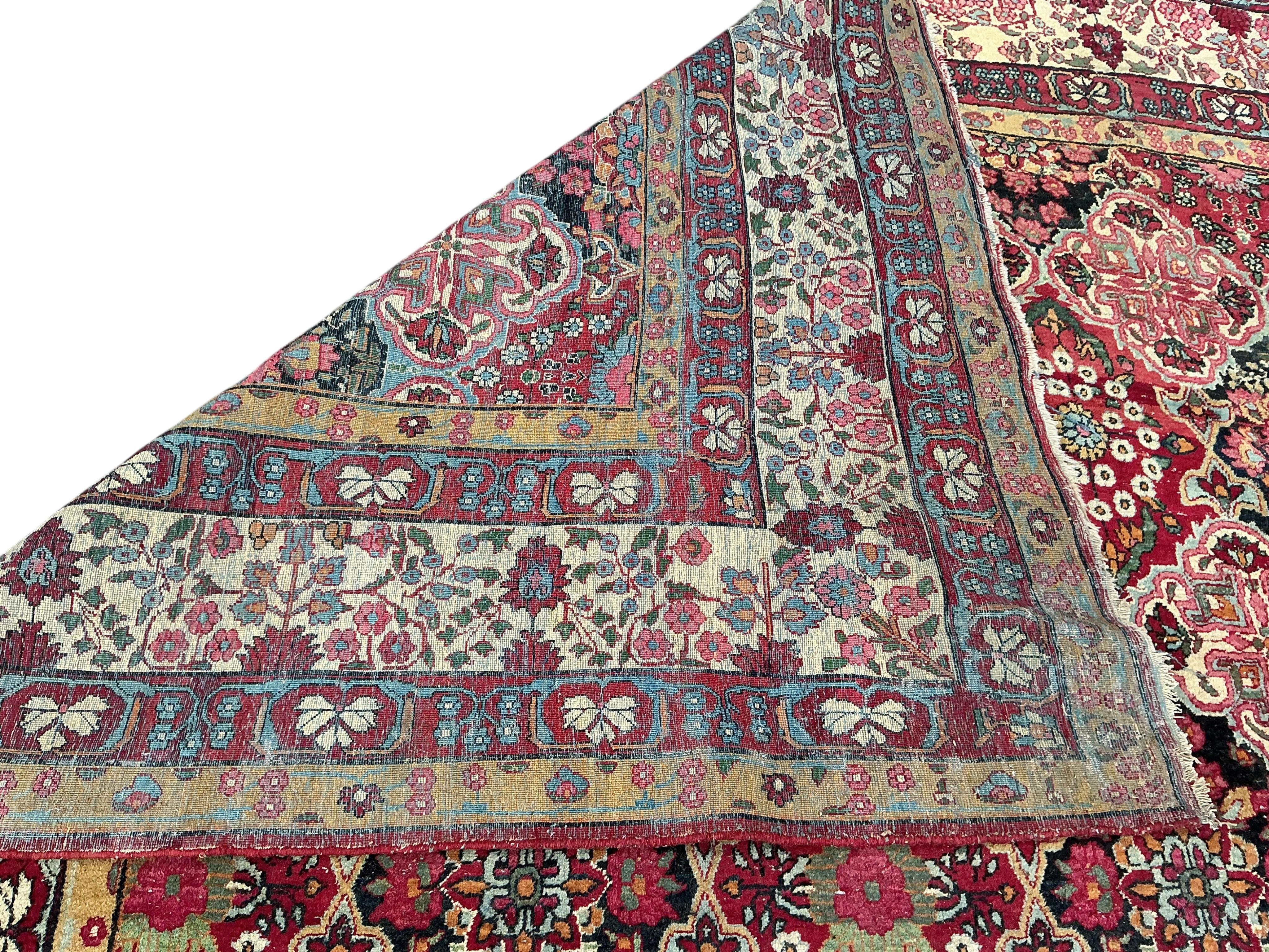 An Agra multi coloured carpet, the ground woven with interlocking oval medallions, 455 x 315cm